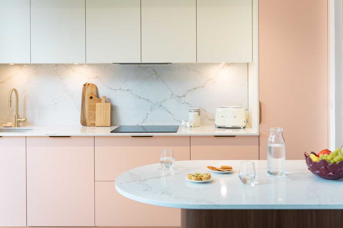 Cuisine avec façade rose et plan de travail en marbre de Carrare